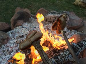 Roasting Brats Over A Campfire